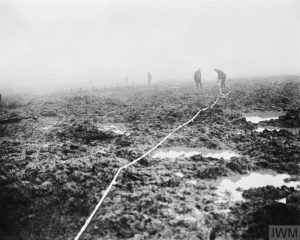 THE BATTLE OF PASSCHENDAELE, JULY-NOVEMBER 1917 (CO 2253) Assault on Passchendaele 12 October - 6 November: Canadian Pioneers laying tape through the mud for a road to Passchendaele. Copyright: © IWM. Original Source: http://www.iwm.org.uk/collections/item/object/205193444