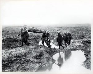 Canadian soldiers carrying the wounded. Photo via Wikimedia Commons. 