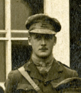 Close-up sepia toned image of a First World War officer with cap and thin moustache