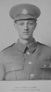 young WWI soldier with East Surrey Regiment cap badge on hat.